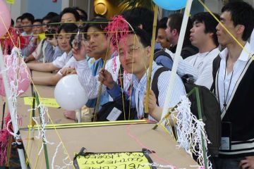 employees collaborate to complete bridging the divide creative team building activity