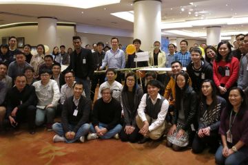 employees group photo bridging the divide collaborative team building activity