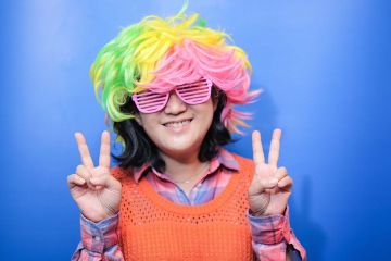 woman with funny wig unny wig and a big bow tie in the picture fun team building activity