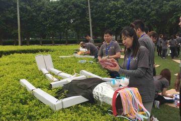 team collaborate to construct a puppet creative team building activity