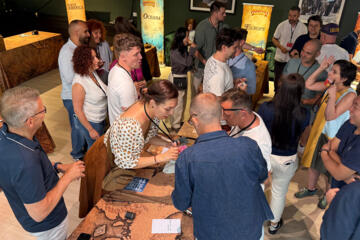 Teams collaborating to solve continent-themed puzzles during the Passport to Adventure experience.