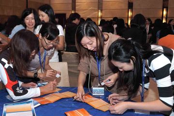 team collaborate to complete knowing me knowing you team building activity