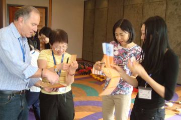 team collaborate to complete knowing me knowing you team building activity