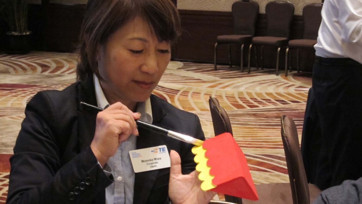 woman building toy for children team building CSR activity