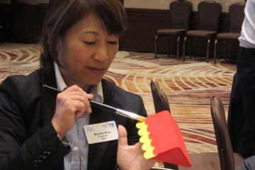 woman painting a toy for a child toy factory social responsibility team building activity