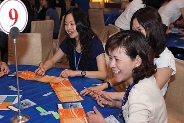 team collaborate to complete knowing me knowing you team building activity