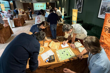 Conference delegates participating in Passport to Adventure collaborative team building activity.