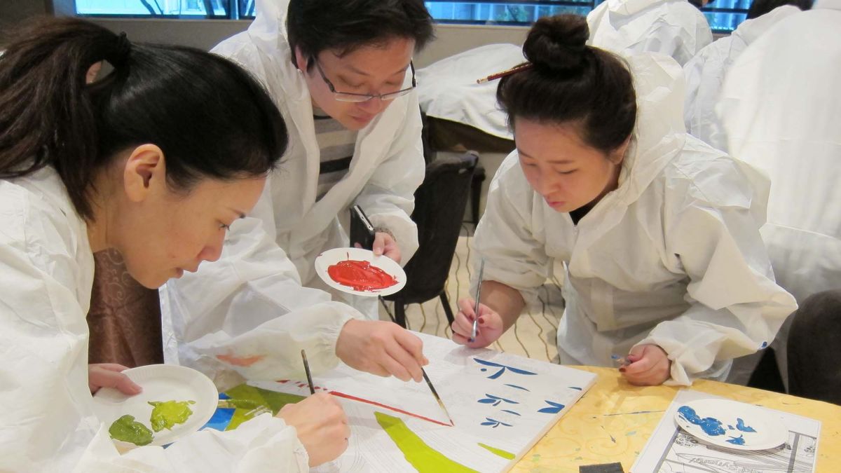 three employees paint a picture together for the big picture activity