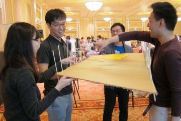 team collaborate to complete bridging the divide team building programme resized