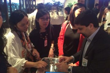 employees collaborating to complete beat the box team building activity