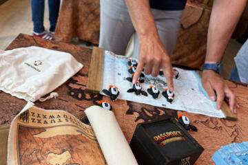 Participants solving a penguin puzzle during the Passport to Adventure indoor team building activity