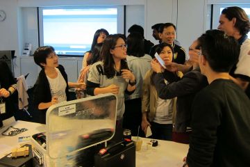 employees collaborating to complete beat the box team building activity