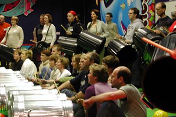 People playing musical instruments in musical team building activity by Catalyst Global.