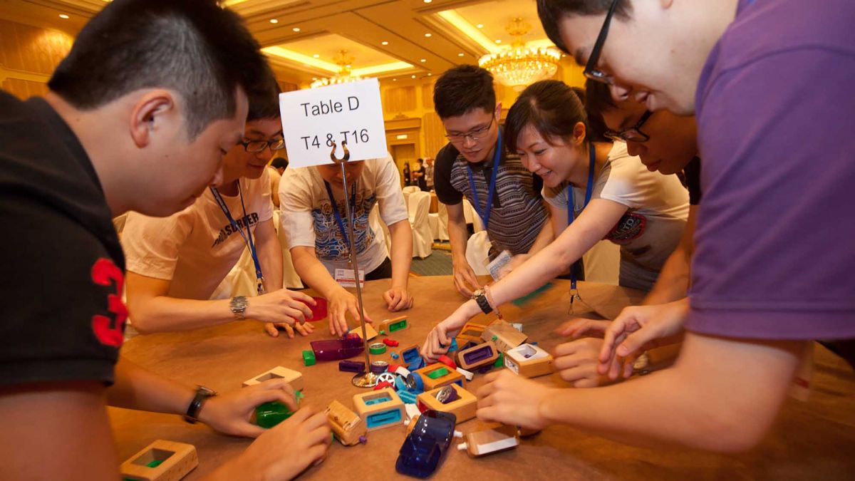 team collaborates to complete fun team building activity need 4 speed