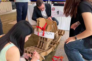 Team assembling cardboard rocking horse during Horses for Causes team building activity