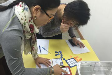 employees collaborating to complete beat the box team building activity