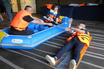 people in raft saving someone