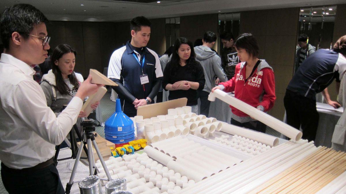 employees collaborate to complete team building activity 2015