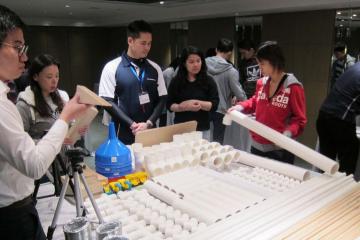 employees collaborate to complete team building activity 2015