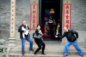 team striking a funny pose outside a building during travel show outdoor team building activity nike