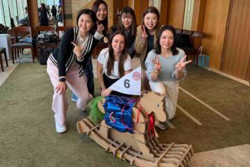 Group problem-solving while building cardboard horse structure