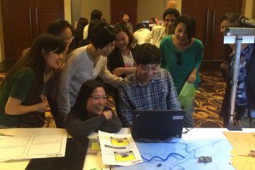 employees collaborate to complete animate team building activity