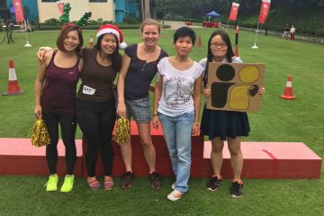 women smiling flat out sleigh ride christmas team building activity