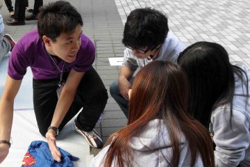 team collaborate to complete rags to riches charity team building event