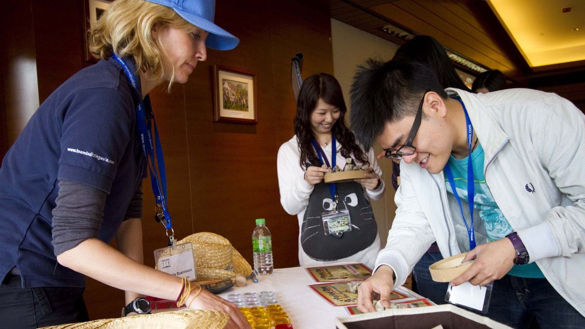 team collaborated to complete team building activity for communication bean around the world