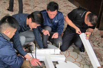 team collaborate to construct a puppet creative team building activity