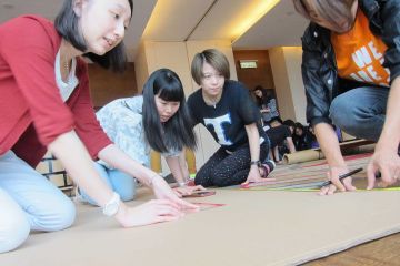 team collaborate to complete flat out formula one team building challenge