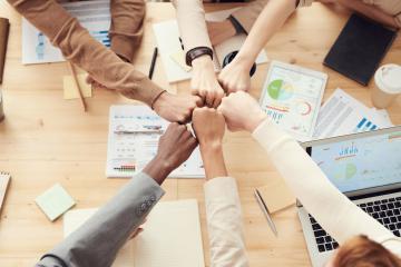 employees fist bumping to success