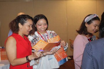 two women happily collaborate in work style networking business game