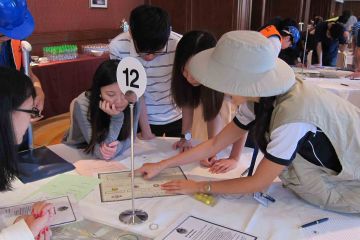 team collaborate to complete rags to riches charity team building event