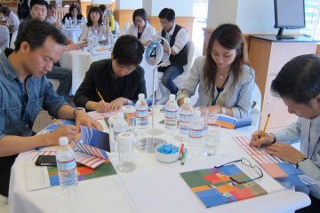 team collaborate to complete knowing me knowing you team building activity