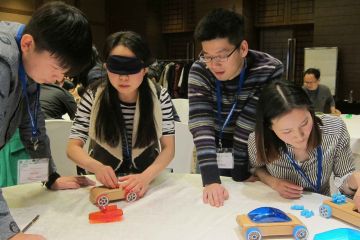 team collaborate to complete need for speed team building business game