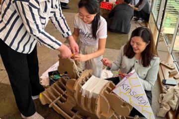 Participants building flat-pack rocking horse in collaborative team challenge