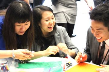 employees collaborate to complete animate team building activity