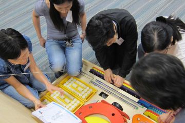 employees collaborate in strategic team building activity