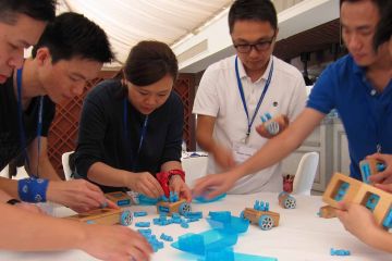 team collaborate to complete need for speed team building business game