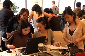 team collaborate at making the news team building activity