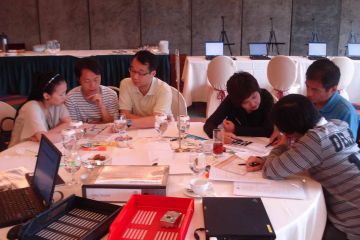 team collaborate at making the news team building activity