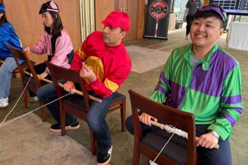 Jockey pulling rope mechanism to race rocking horse across finish line