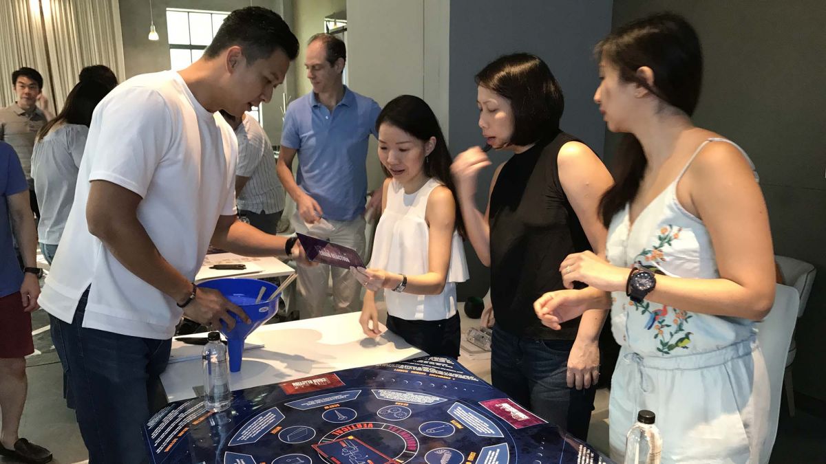 team collaborates to compleate chain reaction table top challenge