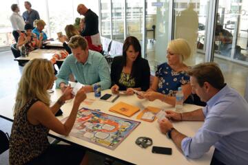 Team collaborating in a customer-focused workshop, discussing strategies to improve client relationships and communication