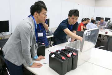 employees collaborating to complete beat the box team building activity