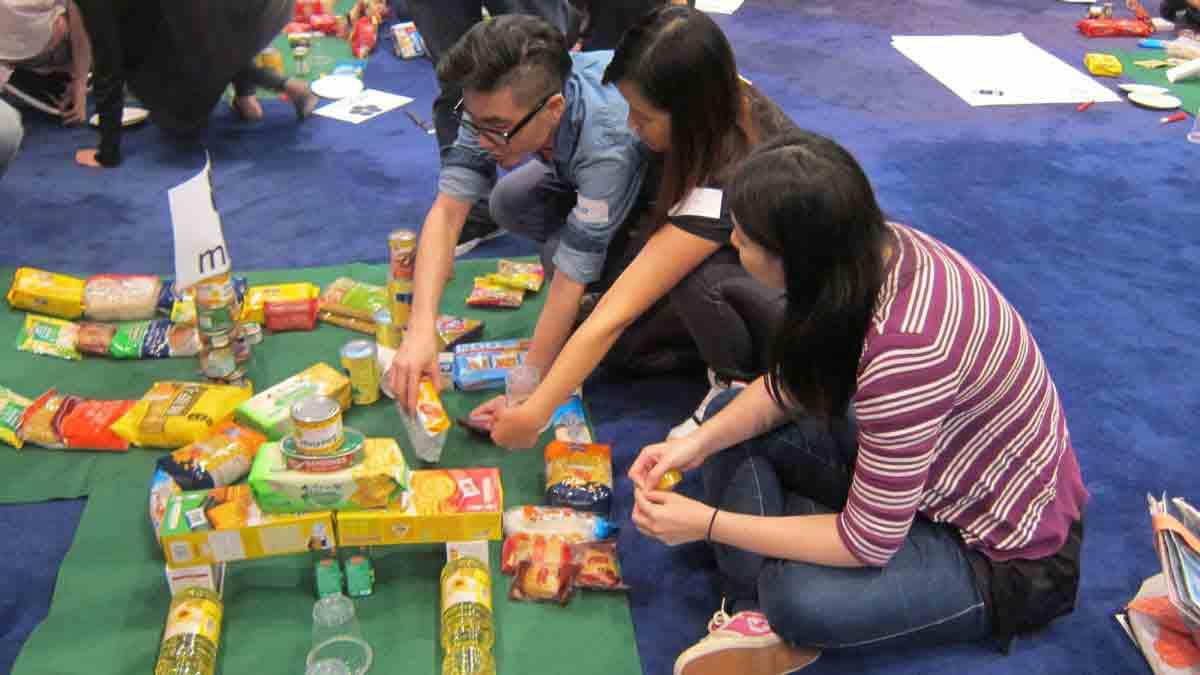 three people managing the resources they have in Catalyst team building activity Hole in One