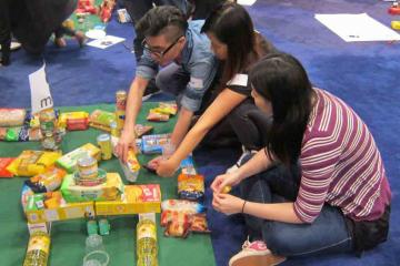 three people managing the resources they have in Catalyst team building activity Hole in One