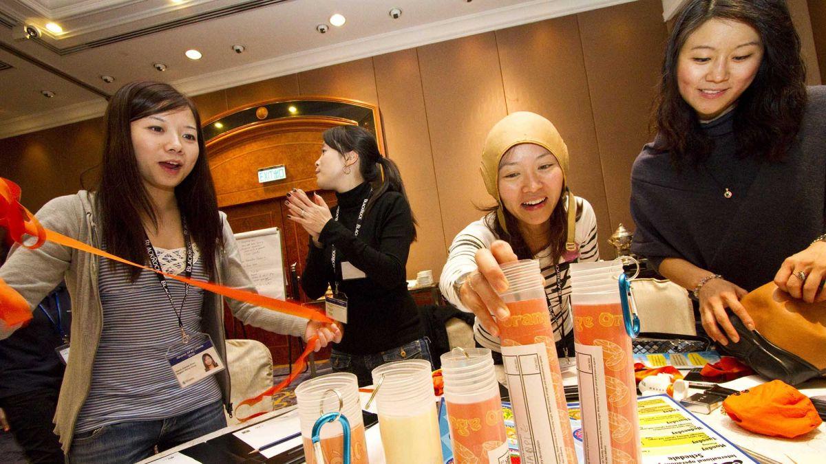 employees have fun completing cooking team building activity kitchen