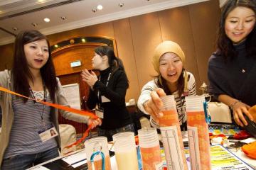 employees have fun completing cooking team building activity kitchen